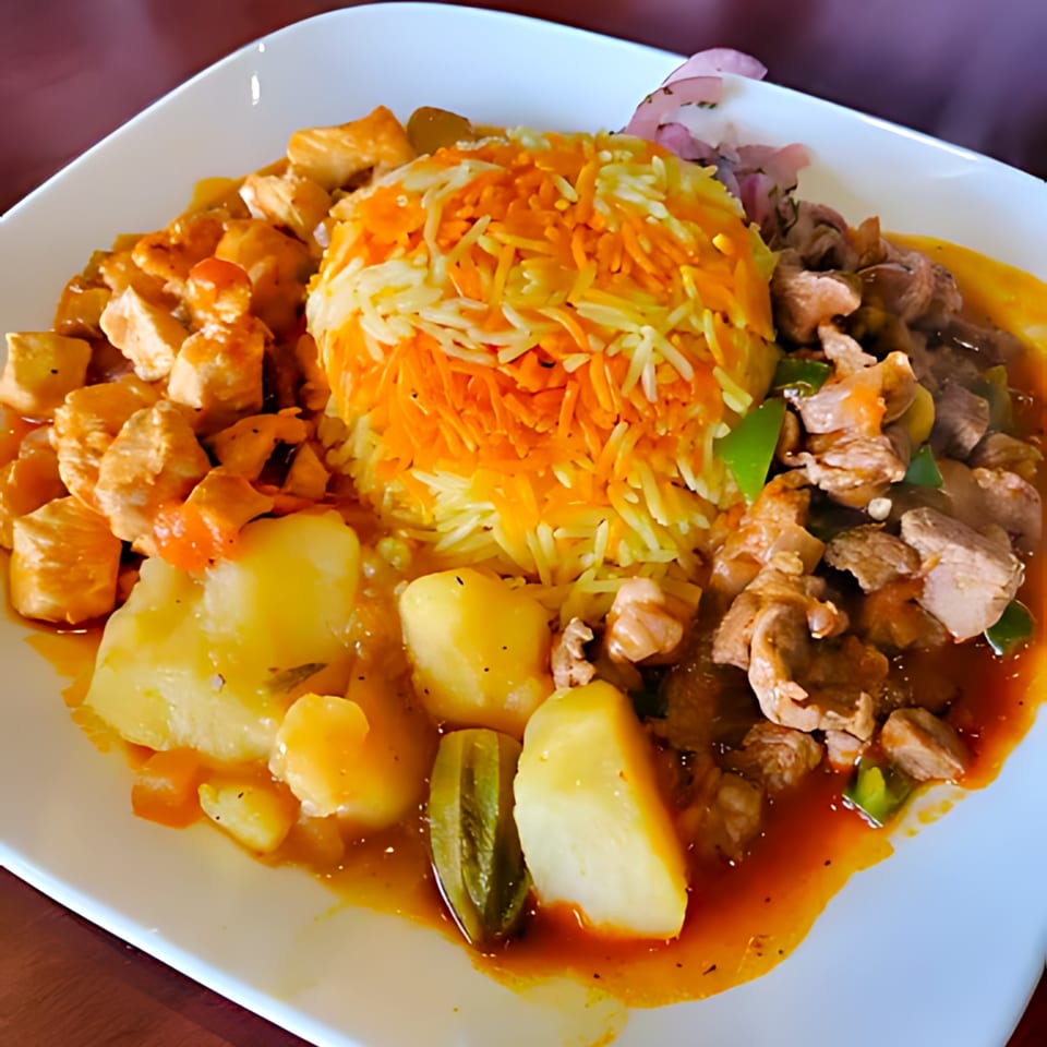 A vibrant Middle Eastern dish with orange and white rice, chicken, beef, potatoes, and okra.